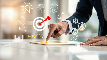 Businessman using digital tablet with holographic icons of target, idea, documents, charts, and teamwork, symbolizing business strategy, digital marketing, planning, and goal achievement.