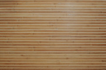 Light brown natural bamboo wall panel texture background.