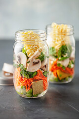 Healthy homemade instant noodles with vegetables in mason jar. Asian  vegetarian lunch idea