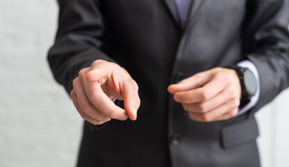 Fototapeta premium Handsome businessman in a suit and tie pointing his finger with isolated white background.