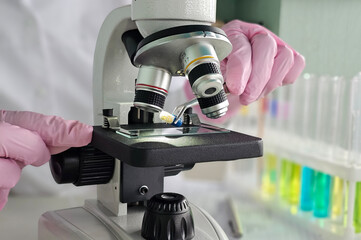 Scientific research underway in a laboratory with a microscope examining samples concept