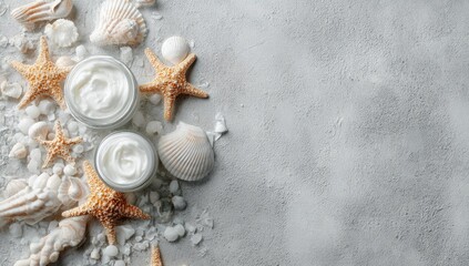 Cream jars, seashells, and starfish on a gray surface (1)