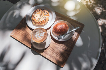 Break time lunch break at Outdoor style cafe. Hot coffee latte art with bread Bagel cream cheese...