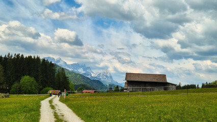 Obraz premium rural landscape with a house and mountains
