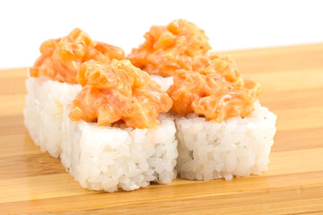 Fresh Sushi with Spicy Salmon Topping on Wooden Plank
