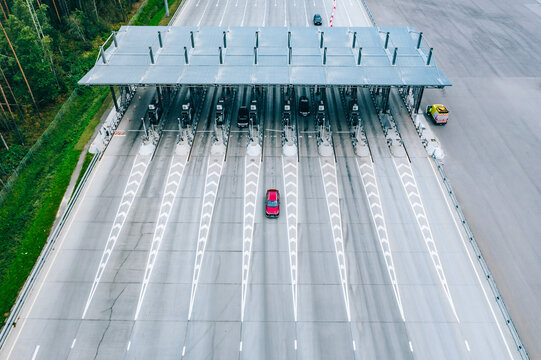 Fototapeta Aerial drone view on motorway with toll collection point, freeway toll booth. Checkpoint on the road. Car traffic transportation on multiple lanes highway road and toll collection gate