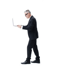 Businessman with laptop walking in profile, isolated on white background.