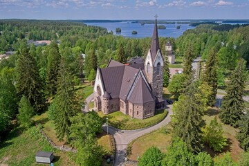 Aerial view of old Savitaipale granite church in spring in cloudy weather, Savitaipale, Finland.