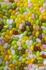 bright background for designer made of colorful jelly beans or candies, vertical photo