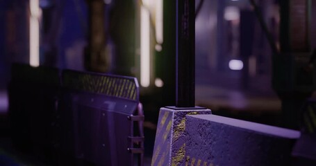 This setting features a striking blend of colors and lights in an architectural space. The design highlights sharp lines and a futuristic ambiance at night, creating a captivating atmosphere.