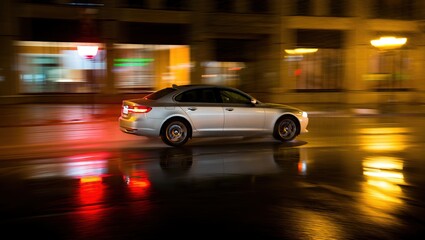 Car speeding through wet urban street at night, motion blur and glowing reflections enhance dynamic speed, energy, and city nightlife.