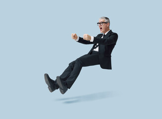 Shocked businessman driving an imaginary car and having an accident