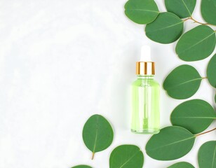 Light green serum bottle surrounded by eucalyptus leaves on a marble background