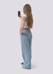 Young woman using a smartphone back view