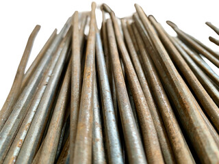 Close-up of stacked rusty steel rebar rods isolated on white background, rough texture and corrosion detail. Perfect for construction, engineering, building, and architecture themes.