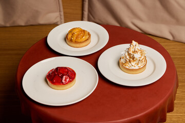 Delicious Mini Pastries with Various Toppings Beautifully Arranged on Plates for Serving