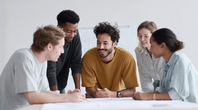 Diverse team collaborating on a project, reviewing plans together. Represents teamwork, innovation, and shared vision. Perfect for business, design or educational contexts.