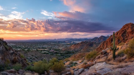 Scenic mountain desert panorama at sunset overlooking a city landscape. Vibrant evening sky with multicolor clouds for travel and nature concept.