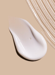 samples of cosmetic care products smear of cream gel texture on a beige background