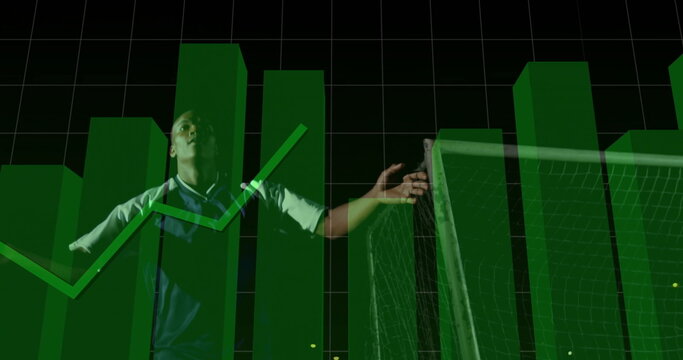 Extending arms athlete wearing blue sportswear in studio next to goalpost, with green data charts