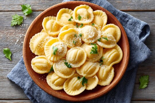 Italian cappelletti with parsley and grated cheese on wooden plate