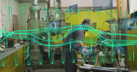 Operating technician adjusting milling machine in machine shop with digital overlays, copy space