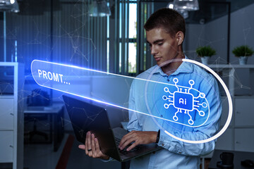 Obraz premium Young man using a laptop in a modern office while interacting with artificial intelligence technology display