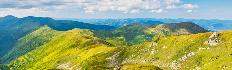 Fototapeta premium Green mountains and hills panorama landscape with blue sky, valley in mountains landscape
