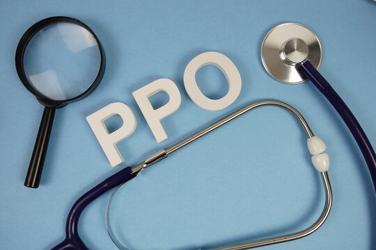 PPO abbreviation of Preferred Provider Organization alphabet letters with magnifying glass and stethoscope on blue background