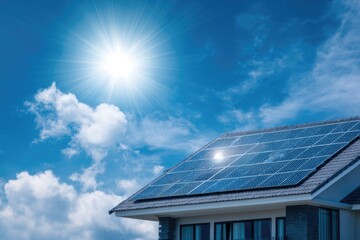 Naklejka premium Modern house rooftop with shiny solar panels, blue sky with light clouds, eco friendly home concept.