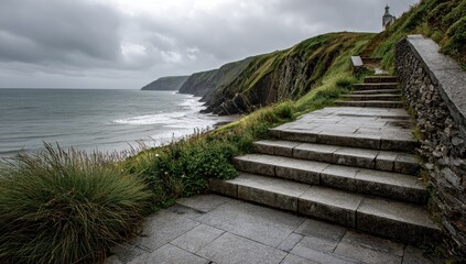 Coastal path steps leading down to a stormy sea