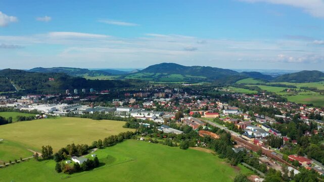Right side drone shot of czech small city with beskydy mountains