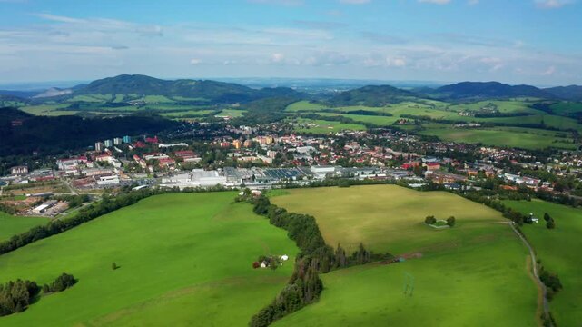 Dolly drone shot of czech small city with beskydy mountainsin czech republic