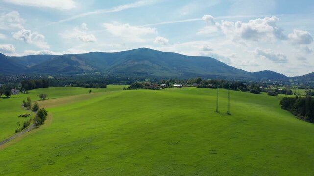 Dolly drone shot of czech small village and field with beskydy mountains