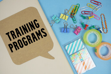 Training Programs text with stationery on cover notebook background