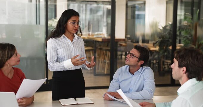 Indian businesswoman make speech standing in front of business partners