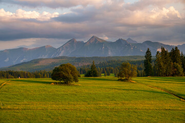 Mountain Range and Green Fields at Sunset