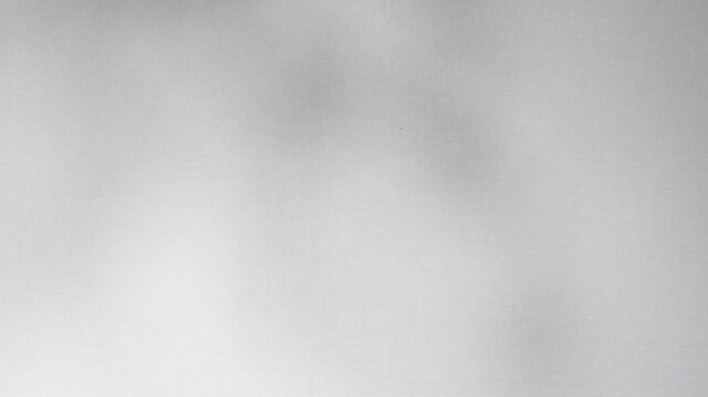 Smooth white fabric shadow creating gentle waves, offering an elegant background for backgrounds and textures, designs minimalist video 4k