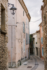 Fototapeta premium Cozy street of old Provençal town in soft sunset light, romantic Mediterranean atmosphere.