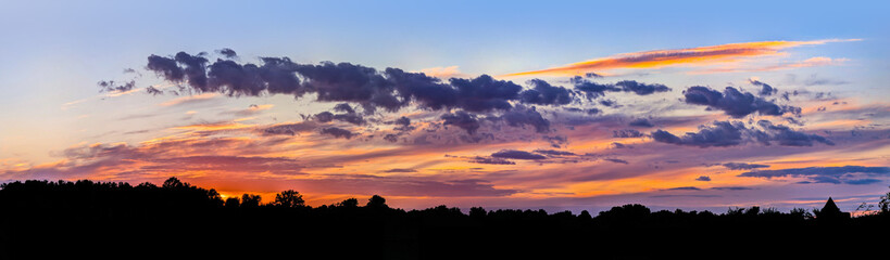 Highly detailed dramatic background sunset with impressive play colors reflected clouds refraction pink, purple, yellow, red, orange, crimson blue hues. Explosion cloud fragments flying small details