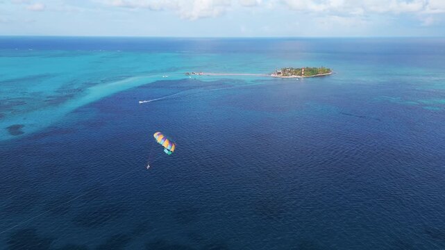 Aerial view of a colorful parasail drifting in the ocean contrasting against the deep blue sea, San Andr&eacute;s, San Andres and Providencia, Colombia.