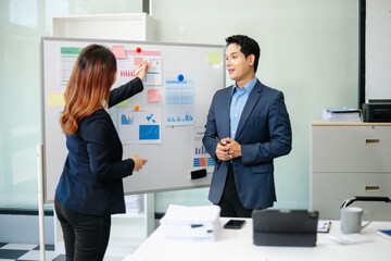 Two busy happy professional business man and woman executive leaders team using laptop working in office