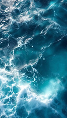 Top-down close-up of the open ocean with deep blue waves and foam
