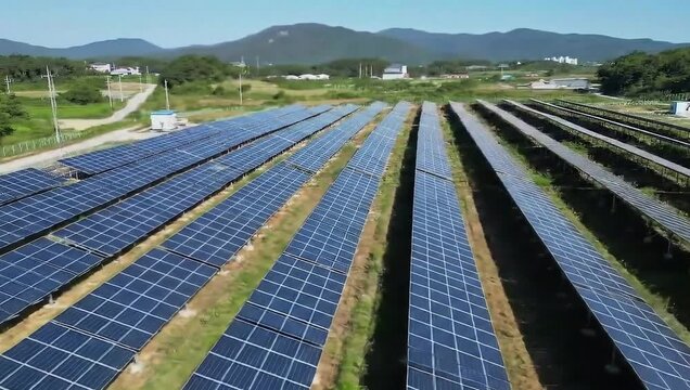 Solar Panel Field Under Blue Sky: A vast expanse of solar panels basks in the bright sunshine, converting sunlight into renewable energy to power a sustainable future.
