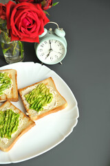 Breakfast consisting of toast with avocado and eggs. Healthy breakfast.
