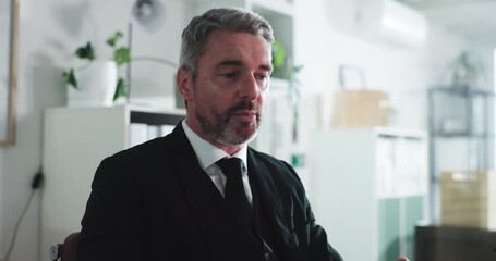 Business, video call and man in office, tech and financial agency with stock market. Mature person, virtual chatting and investor with online meeting, webinar and explain investment deal with app - Powered by Adobe