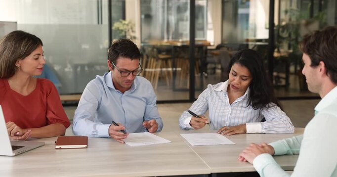 Multinational business parties signing contract shaking hands conclude agreement