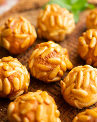 Panellets with pine nuts and almonds. A typical Catalan dessert made with marzipan and nuts.