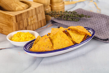 Corn nachos chips with cheese dip