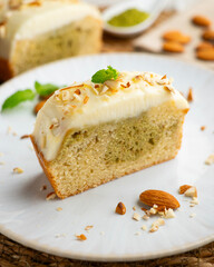 Slice of Japanese sponge cake with matcha green tea and a butter and cream cheese topping.